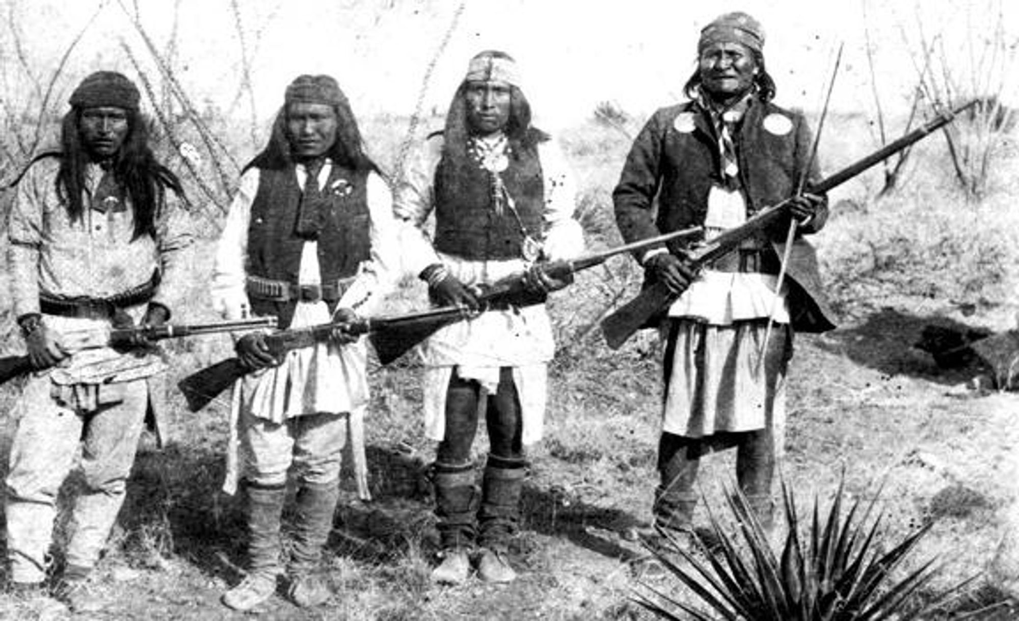 Captioned: "Geronimo, Yanozha (Geronimos´s brother-in-law), Chappo (Geronimo´s son by his second wife), and Fun (Yanozha´s half brother) (right to left) in 1886." Photo by C. S. Fly